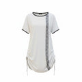 Short sleeve tunic top with adjustable side ties and contrast trim.